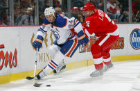 DETROIT, MI - NOVEMBER 11: Ryan Smyth #94 of the Edmonton Oilers carries the puck as he is checked by Nicklas Lidstrom #5 of the Detroit Red Wings during their NHL game at Joe Louis Arena November 11, 2011 in Detroit, Michigan. (Photo by Dave Sandford/Getty Images)