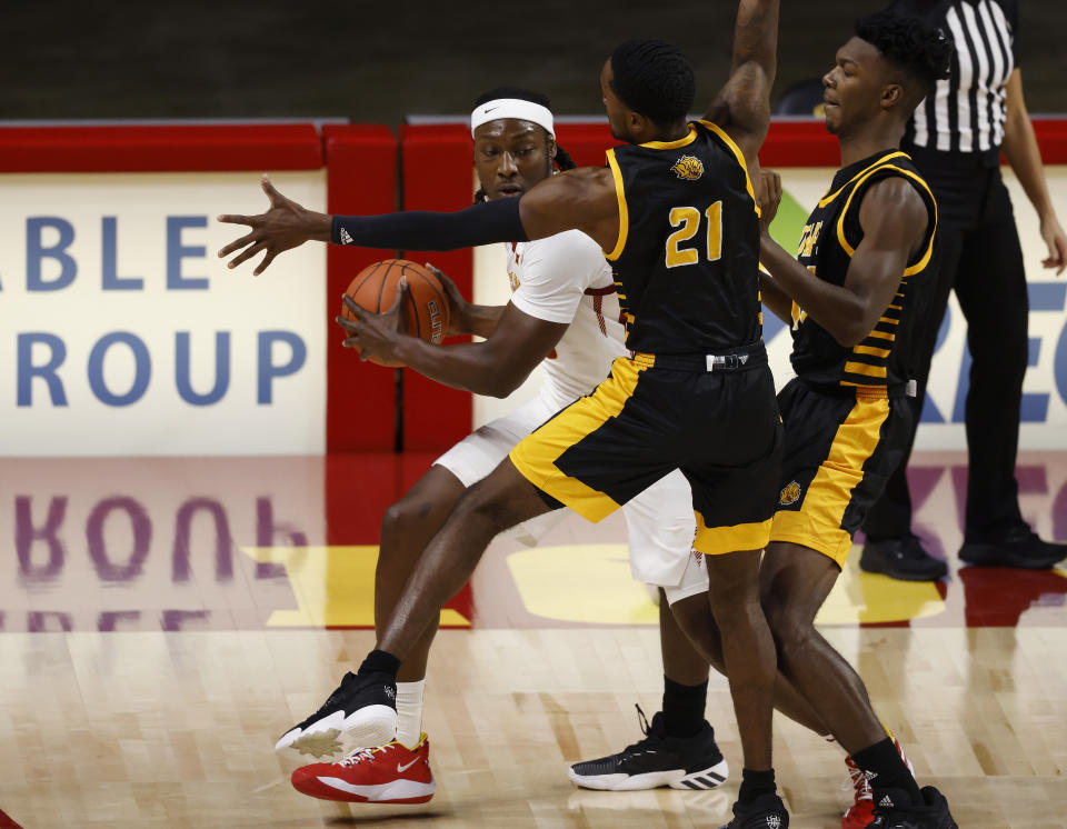 Iowa State forward Solomon Young, left, looks for a pass as Arkansas-Pine Bluff guard Shaun Doss, cente,r and forward Alvin Stredic, right, defend during the first half of an NCAA college basketball game, Sunday, Nov. 29, 2020, in Ames, Iowa. (AP Photo/Matthew Putney)