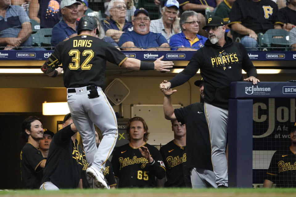 Pittsburgh Pirates' Henry Davis (32) is congratulated at the dugout after hitting a two-run home run during the second inning of a baseball game against the Milwaukee Brewers, Friday, Aug. 4, 2023, in Milwaukee. (AP Photo/Aaron Gash)