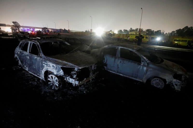 Burned vehicles are seen following a fire that broke out in?Egypt's Shuqair-Mostorod crude oil?pipeline, at the beginning of Cairo-Ismailia road