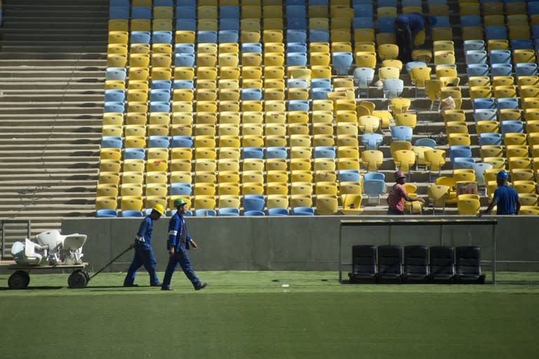 Workers carry chairs before a visit of the FIFA Secretary General Jerome Valcke at the Maracana stadium in Rio de Janeiro, Brazil, on May 15, 2013. An estimated 74,000 people are expected to watch Sunday's friendly game between Brazil and England, the second test for the stadium inaugurated on April 27 after a multi-million-dollar 30-month renovation