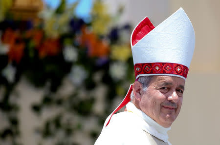 FILE PHOTO: Bishop Juan Barros looks on as Pope Francis leaves at the end of a mass at the Lobito beach in Iquique, Chile January 18, 2018. Picture taken January 18, 2018 REUTERS/Alessandro Bianchi/File Photo