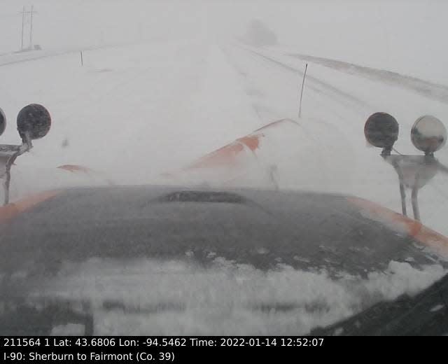 This image, provided by the Minnesota Department of Transportation, shows the view from a snowplow clearing a portion of I-90 in the south central part of the state as snow falls just before 1 p.m. Central time on Friday.