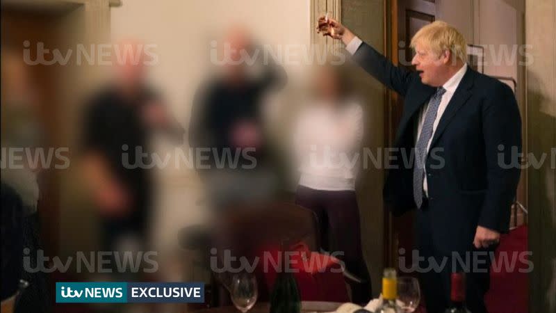 A handout picture shows British Prime Minister Boris Johnson raising a glass during a party at Downing Street, amid the coronavirus disease (COVID-19) pandemic in London