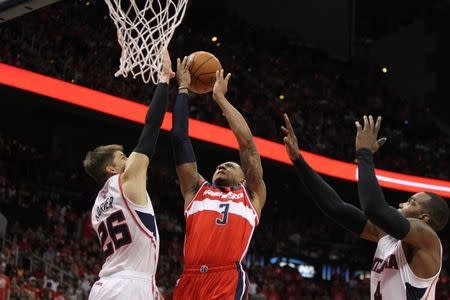 May 3, 2015; Atlanta, GA, USA; Washington Wizards guard Bradley Beal (3) shoots over Atlanta Hawks guard Kyle Korver (26) and forward Paul Millsap (4) in the second quarter in game one of the second round of the NBA Playoffs. at Philips Arena. Mandatory Credit: Brett Davis-USA TODAY