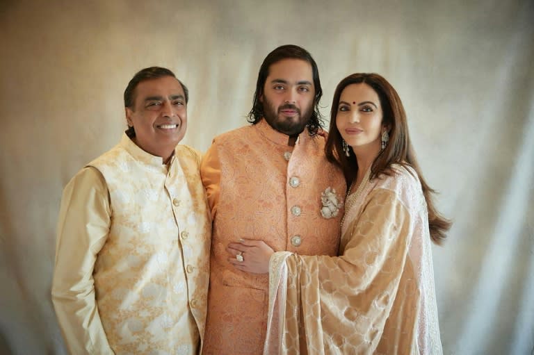 This handout photograph taken and released by Reliance on March 2, 2024, shows billionaire tycoon Mukesh Ambani (L) and his wife Nita Ambani (R), and their son Anant Ambani (-)