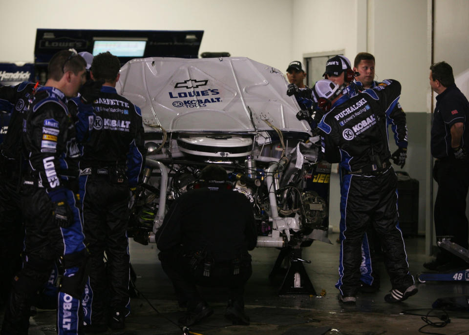 DAYTONA BEACH, FL - FEBRUARY 27: Crew members work on the #48 Lowe's Chevrolet driven by Jimmie Johnson in the garage after being involved in an on track incident during the NASCAR Sprint Cup Series Daytona 500 at Daytona International Speedway on February 27, 2012 in Daytona Beach, Florida. (Photo by Jerry Markland/Getty Images for NASCAR)