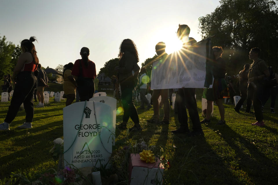 People hold signs saying "Say Their Names" and pay tribute to George Floyd and other Black lives lost to police brutality on the three-year anniversary of George Floyd's death at the Say Their Names Cemetery, Thursday, May 25, 2023, in Minneapolis. The murder of Floyd at the hands of Minneapolis police, and the fervent protests that erupted around the world in response, looked to many observers like the catalyst needed for a nationwide reckoning on racism in policing. (AP Photo/Abbie Parr)