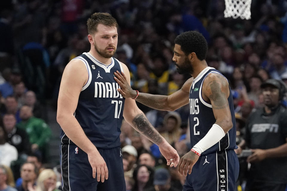 Dallas Mavericks guard Luka Doncic (77) gets a pat from teammate guard Kyrie Irving (2) during the second half of an NBA basketball game against the Los Angeles Lakers in Dallas, Sunday, Feb. 26, 2023. (AP Photo/LM Otero)