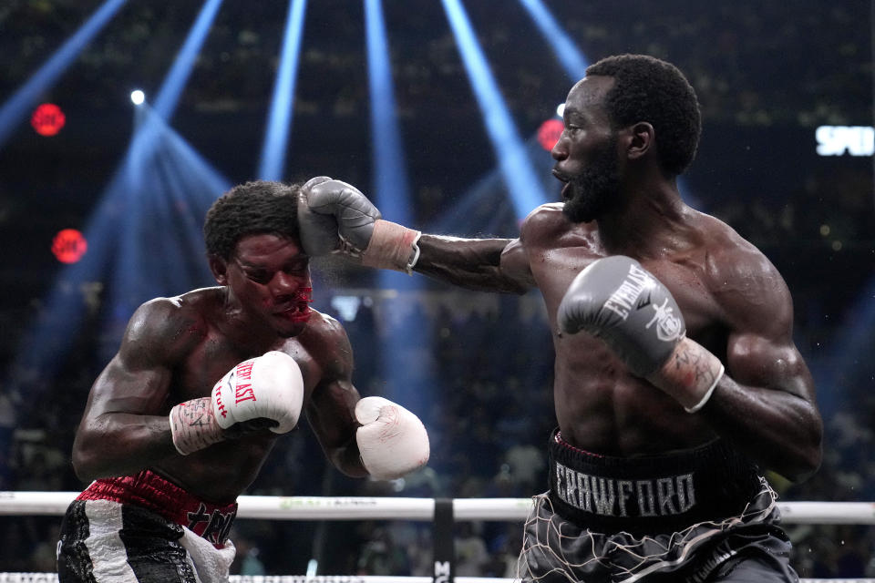 Terence Crawford, right, hits Errol Spence Jr. during their undisputed welterweight championship boxing match, Saturday, July 29, 2023, in Las Vegas. (AP Photo/John Locher)