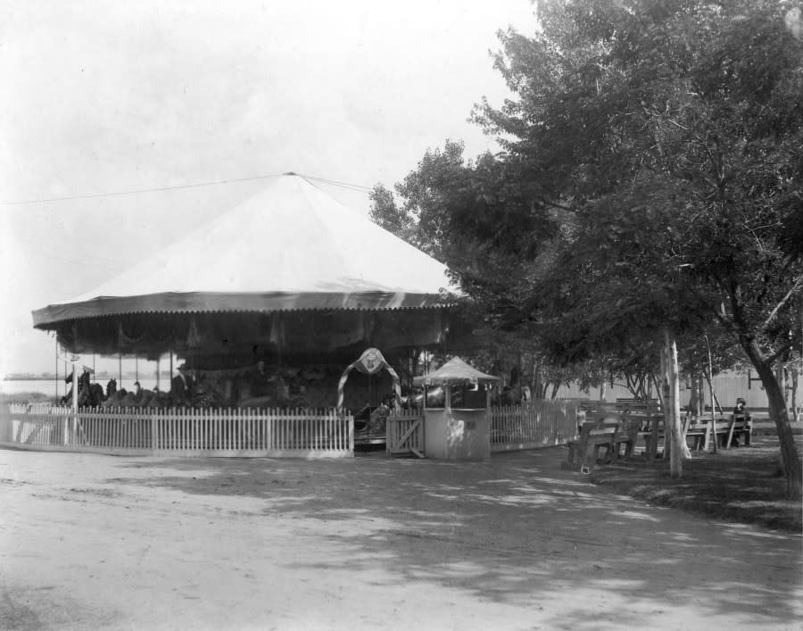 View of Manhattan Beach amusement park in Denver, Colorado; shows a merry-go-round or carousel, and Sloans Lake (Denver Public Library Special Collections, X-19526)