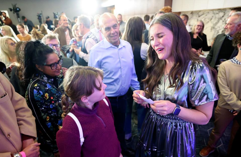 Salt Lake City Mayor Erin Mendenhall reacts to a congratulations card from Violet Wilson, left, after preliminary results show her in a strong lead at an election night watch party for her reelection campaign in the same office building that houses her campaign headquarters in downtown Salt Lake City on Tuesday, Nov. 21, 2023. | Kristin Murphy, Deseret News