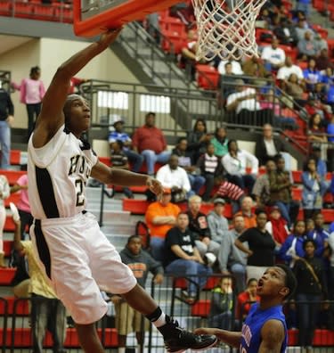 Trey Johnson scores the game-winning basket for Milwood on his own hoop — Bryan Terry/The Oklahoman