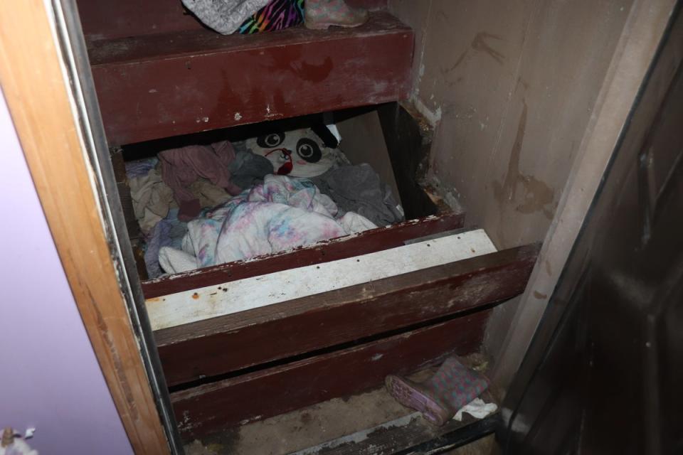 The girl and her abductor were found hiding underneath the stairs (pictured)