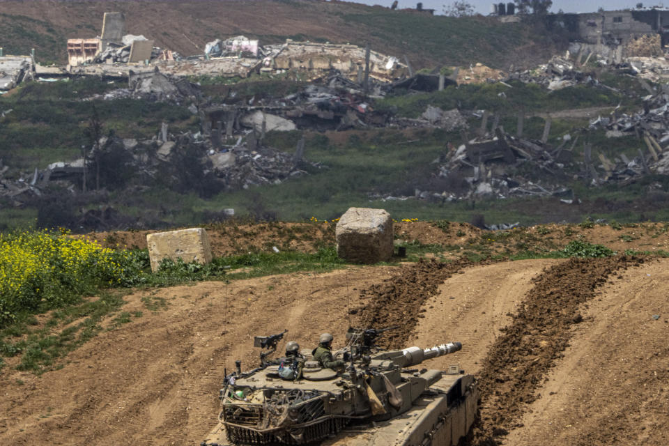 Israeli soldiers drive a tank on the border with Gaza Strip, as seen from southern Israel, Tuesday, March 19, 2024. (AP Photo/Ariel Schalit)