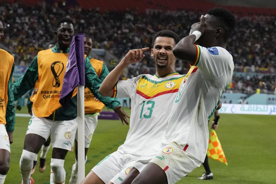 Senegal's Ismaila Sarr, right, celebrates with teammates after scoring a penalty, the opening goal of his team, during the World Cup group A soccer match between Ecuador and Senegal, at the Khalifa International Stadium in Doha, Qatar, Tuesday, Nov. 29, 2022. (AP Photo/Natacha Pisarenko)