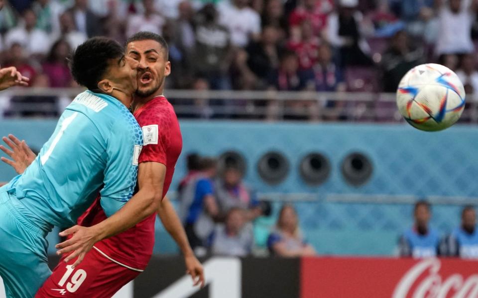 Iran's goalkeeper Alireza Beiranvand collides with Iran's Majid Hosseini, right, during the World Cup group B soccer match between England and Iran at the Khalifa International Stadium - AP