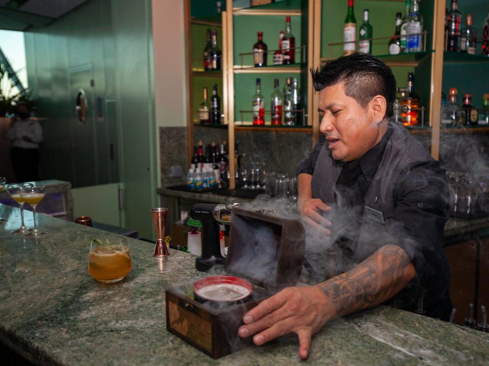 a bartender preparing a drink at Eden