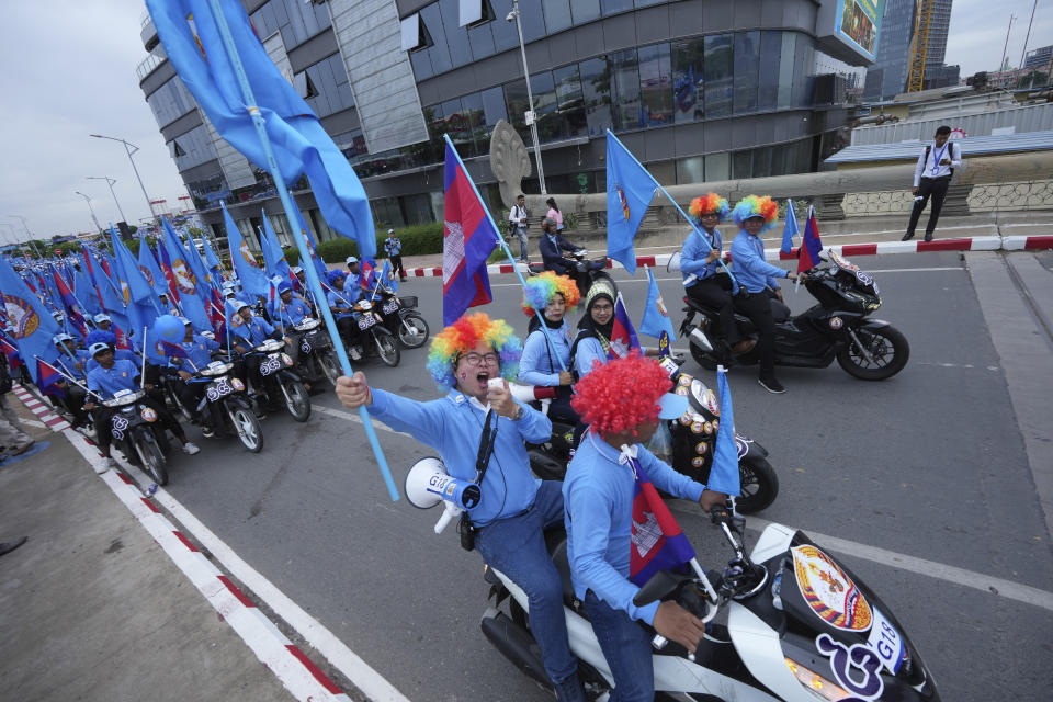 Supporters participate in a procession to mark the end of an election campaign of the Cambodian People's Party in Phnom Penh, Cambodia, Friday, July 21, 2023. The three-week official campaigning period ended Friday for the July 23 general election. Eighteen parties are contesting the polls, but Prime Minister Hun Sen's ruling Cambodian People's Party is virtually guaranteed a landslide victory. (AP Photo/Heng Sinith)