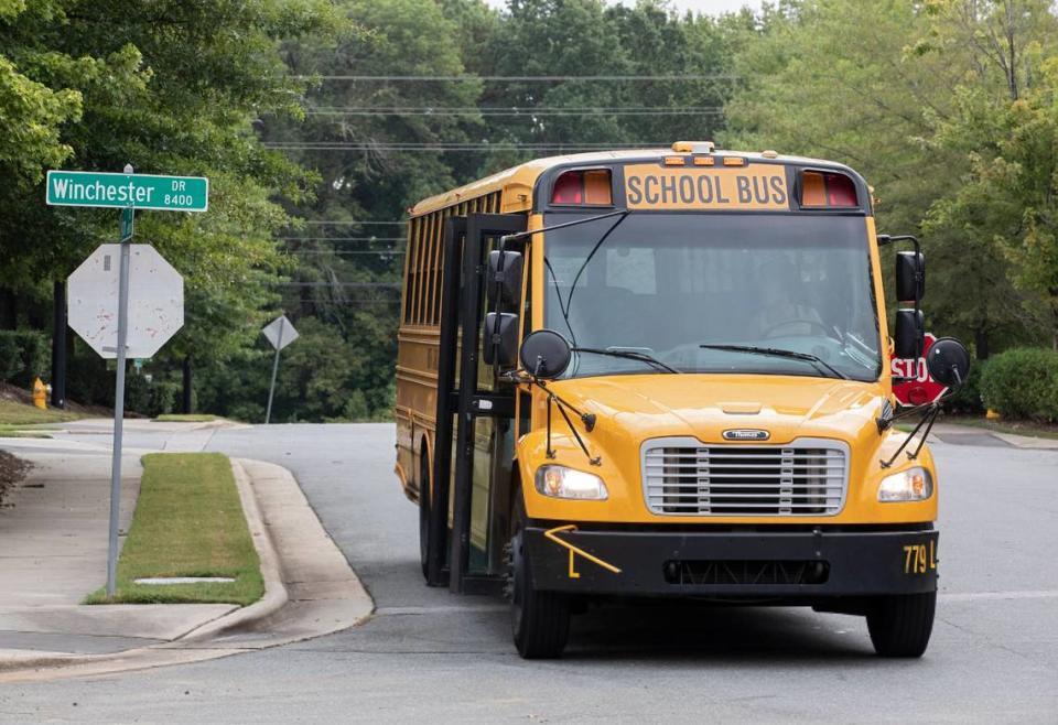 A school bus arrives at Winchester Drive and Paula Ann Court en route to Pleasant Grove Elementary School on the first day of school for Wake County Public School System students, Monday, Aug. 28, 2023, in Raleigh, N.C.