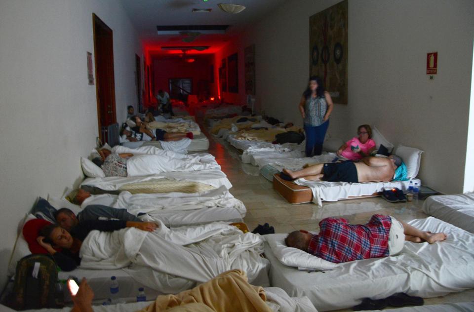 <p>Holidaymakers bed down in the corridors of the Theatre building in the Dreams Hotel in Punta Cana, Dominican Republic, Sept. 7, 2017. (Photo: Huw Evans/REX/Shutterstock) </p>