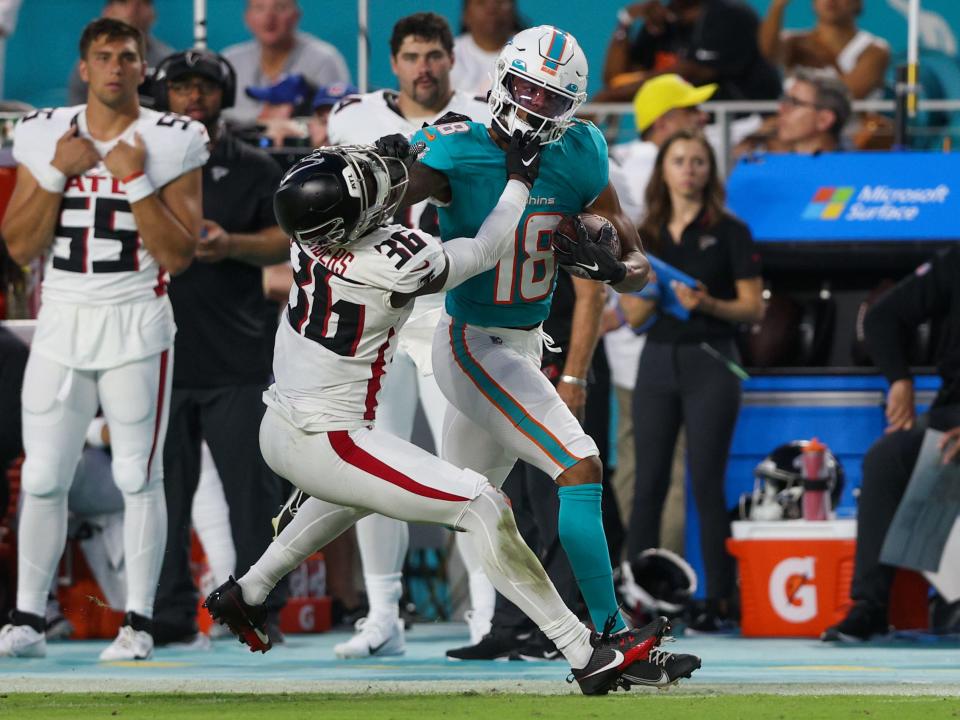 Aug 11, 2023; Miami Gardens, Florida, USA; Miami Dolphins wide receiver Erik Ezukanma (18) stiff arms Atlanta Falcons defensive back Breon Borders (36) in the second quarter at Hard Rock Stadium. Mandatory Credit: Nathan Ray Seebeck-USA TODAY Sports