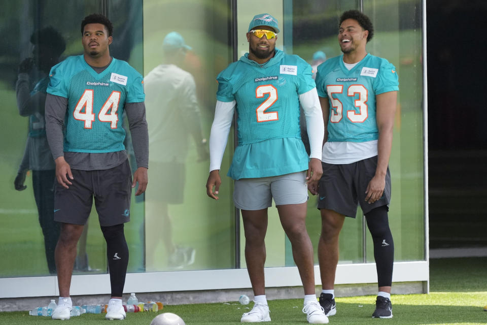 Miami Dolphins linebackers Chop Robinson (44) Bradley Chubb (2) and Cameron Goode (53) look on during an NFL football practice, Tuesday, May 21, 2024, at the Dolphins training facility in Miami Gardens, Fla. (AP Photo/Wilfredo Lee)