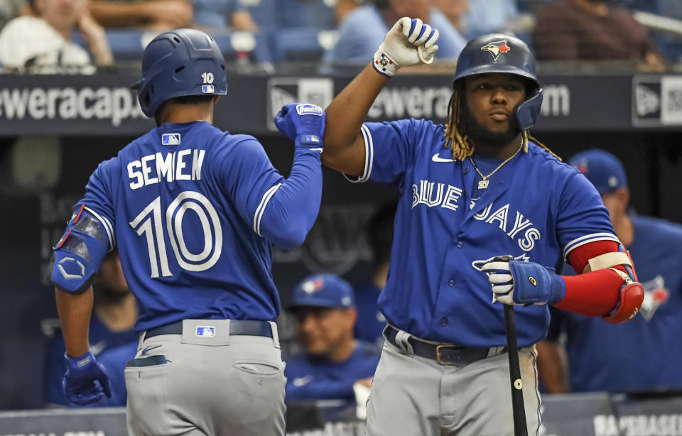 Toronto Blue Jays' Vladimir Guerrero Jr. congratulates Marcus Semien after Semien's two-run home run off Tampa Bay Rays starter Ryan Yarbrough during the third inning of a baseball game Saturday, July 10, 2021, in St. Petersburg, Fla. (AP Photo/Steve Nesius)