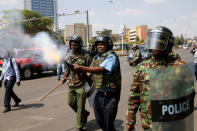 A Kenyan riot policemen fires tear gas to disperse supporters of the opposition National Super Alliance (NASA) coalition during a demonstration calling for the removal of Independent Electoral and Boundaries Commission (IEBC) officials in Nairobi, Kenya September 26, 2017. REUTERS/Baz Ratner