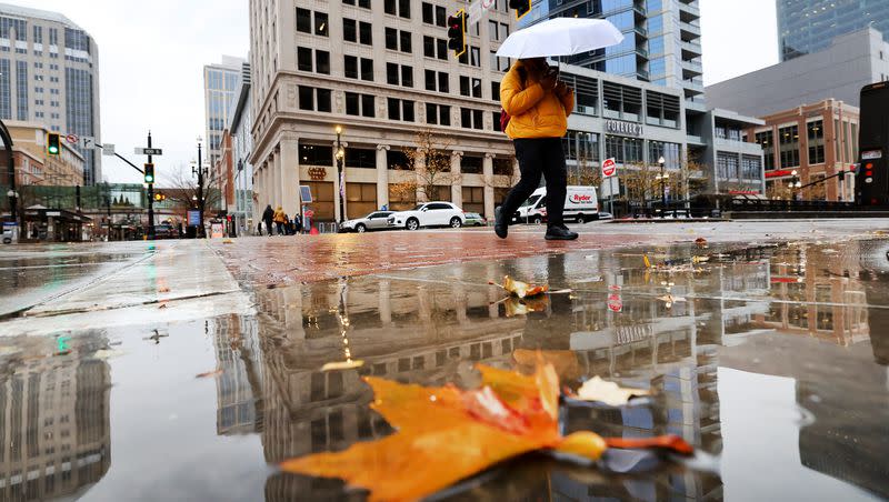 A pedestrian uses an umbrella to shield themselves from the rain in Salt Lake City on Dec. 27, 2022. Utah had its fifth-wettest first half of a water year since 1895, according to data released Monday.