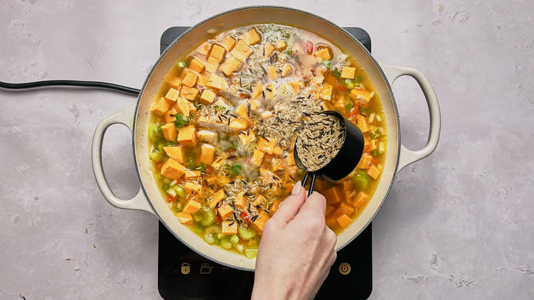 adding rice to skillet