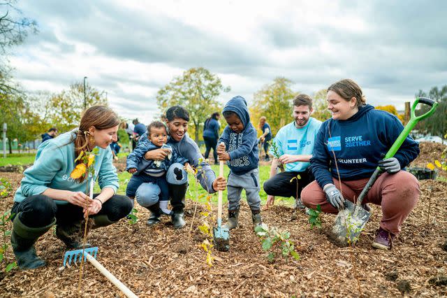 <p>American Express</p> American Express colleagues and their kids participate in a company-sponsored Give2Gether volunteering event, one of many ways American Express encourages its team members to give back.