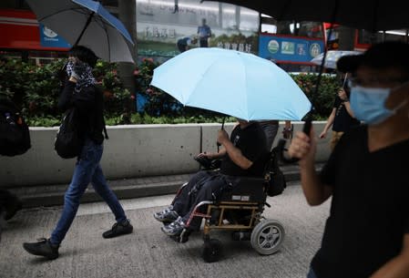 Anti-government demonstrators march in protest against the invocation of the emergency laws in Hong Kong