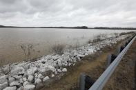 Darkening skies surround the Oktibbeha County Lake near Starkville, Miss., Wednesday, Jan. 15, 2020. The rain-swollen lake is keeping heavy pressure on a dam that is in danger of failing, state and local officials said Wednesday. A breach would affect an estimated 130 properties and nine highways. (AP Photo/Rogelio V. Solis)