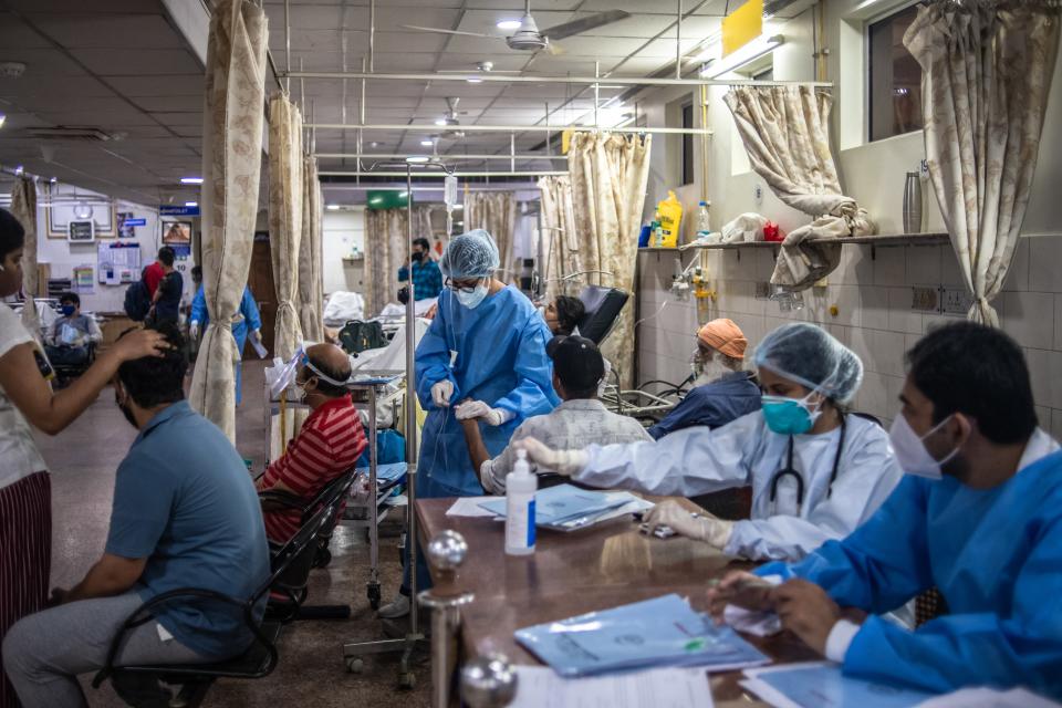 <p>Medical staff attend to Covid-19 patients at a hospital on 6 May, 2021 in New Delhi</p> (Getty Images)