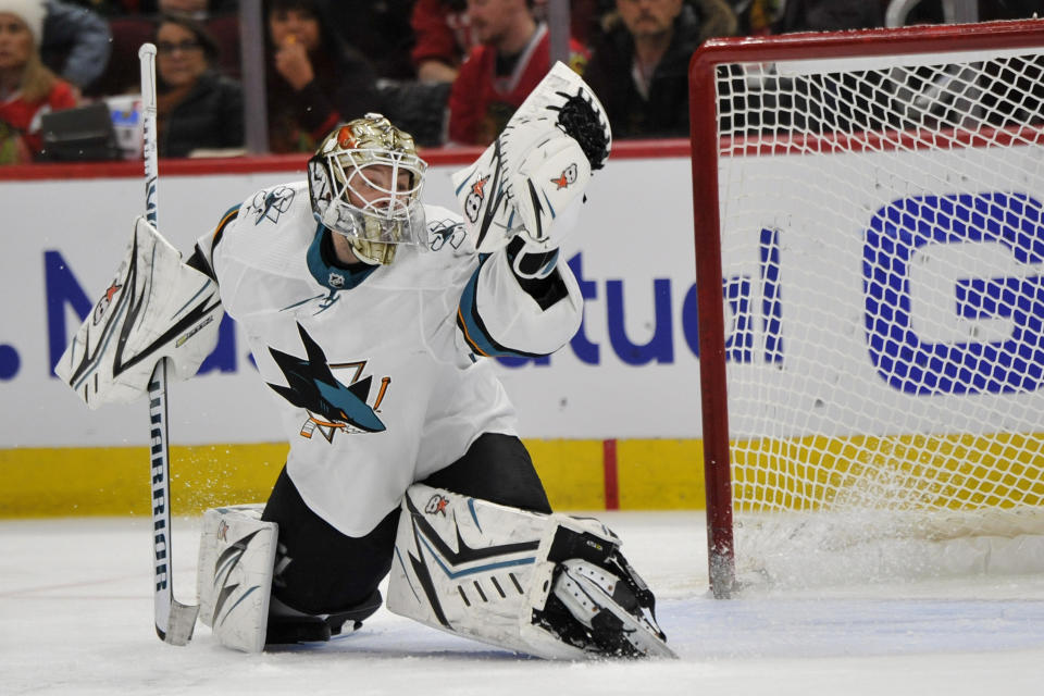 San Jose Sharks goalie Aaron Dell (30) makes a save during the second period of an NHL hockey game against the Chicago Blackhawks Wednesday, March 11, 2020, in Chicago. (AP Photo/Paul Beaty)