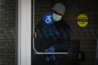 A member of the hospital staff cleans the door at Mount Sinai Hospital, during the outbreak coronavirus disease (COVID-19) outbreak, in New York