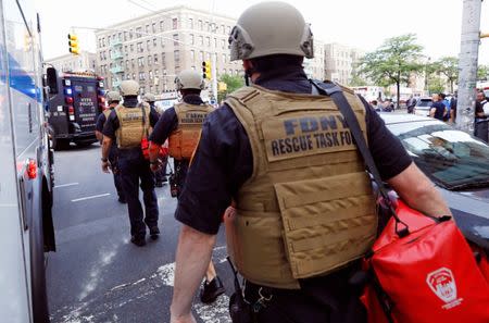 Fire Department rescue workers head towards the scene after an incident in which a gunman fired shots inside the Bronx-Lebanon Hospital in New York City, U.S. June 30, 2017.