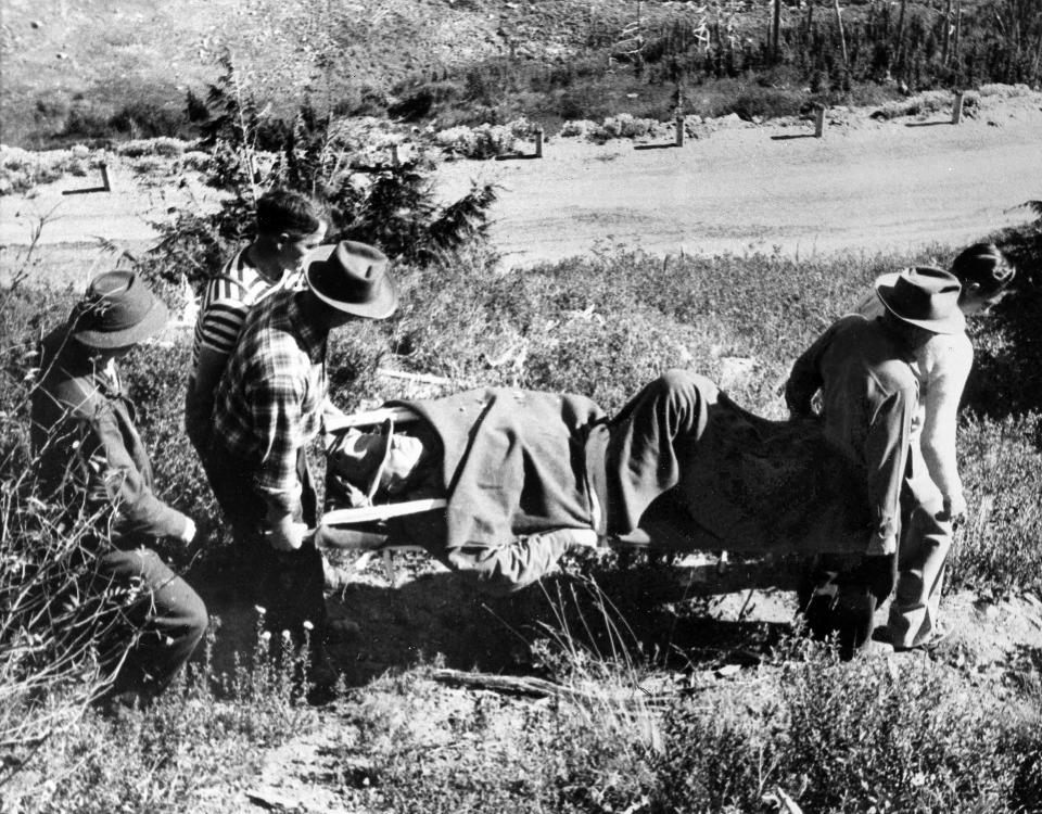 FILE - In this Oct. 2, 1049, file photo, volunteers from a nearby picnic area carry Supreme Court Justice William Douglas down a trail in the rugged Cascade Mountains near Yakima, Wash., after he was thrown from his horse. Justice Ruth Bader Ginsburg has missed a month of Supreme Court arguments as she recovers from lung cancer surgery. But she’s not the first justice to be away for a while and her absence hardly compares with those of some of her predecessors. The day before the Supreme Court began its term in October 1949, Douglas broke 14 ribs and suffered a punctured lung when he was thrown from his horse. He didn't return to the bench for nearly a half year, and his long recovery caused delays in several cases, including challenges to segregation. (AP Photo)