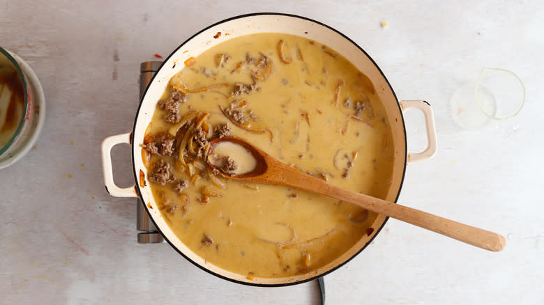 ground beef and heavy cream in a pan