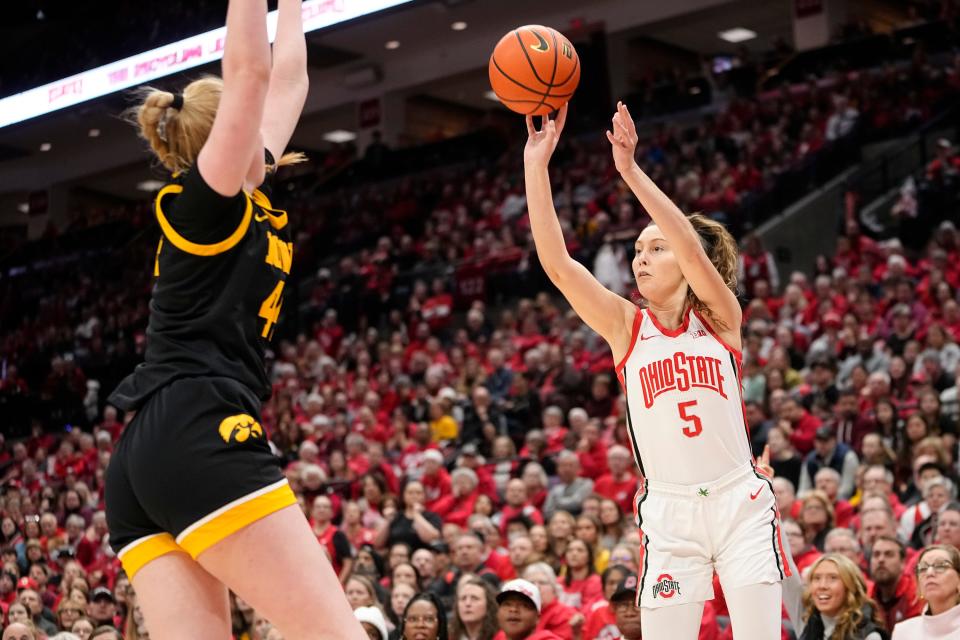 Jan 21, 2024; Columbus, Ohio, USA; Ohio State Buckeyes guard Emma Shumate (5) hits a three pointer in front of Iowa Hawkeyes forward Addison O'Grady (44) during the NCAA women’s basketball game at Value City Arena. Ohio State won 100-92.