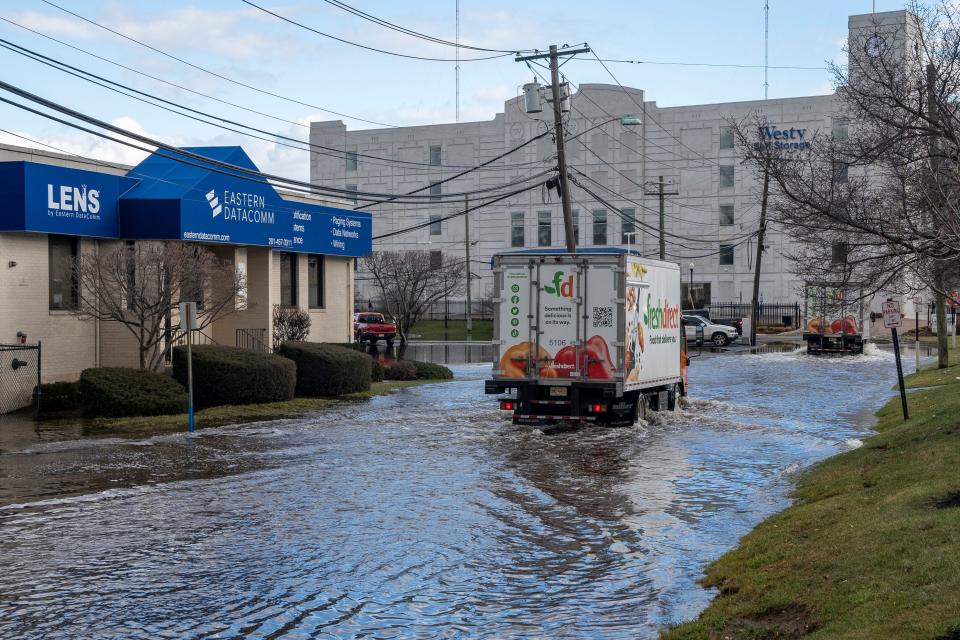 Jan 10, 2024; Hackensack, NJ, USA; A truck navigates flooding on Commerce Way in Hackensack on Wednesday.