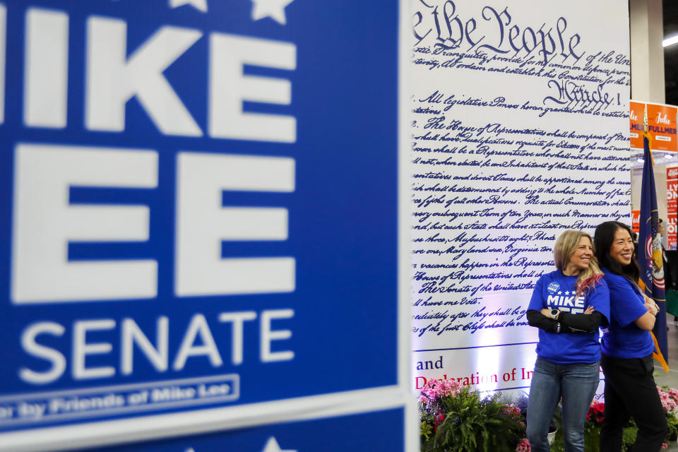 Volunteers pose for a photo at Sen. Mike Lee's booth during the GOP Convention at the Mountain America Convention Center in Sandy, Utah, Saturday, April 23, 2022. (Adam Fondren/The Deseret News via AP)