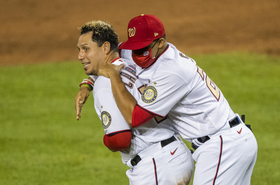 Washington Nationals Juan Soto (22) celebrates with teammate Asdrubal Cabrera, left, after winning 5-3 in a baseball game against the New York Mets in Washington, Tuesday, Aug. 4, 2020. (AP Photo/Manuel Balce Ceneta)