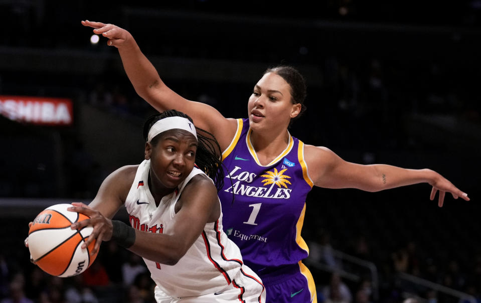 FILE - Washington Mystics center Elizabeth Williams, left, gets a rebound next to Los Angeles Sparks center Liz Cambage during the first half of a WNBA basketball game Tuesday, July 12, 2022, in Los Angeles. Cambage announced on social media that she decided to step away from the WNBA “for the time being” addressing for the first time her contract divorce from the Los Angeles Sparks last month. (Keith Birmingham/The Orange County Register via AP, File)