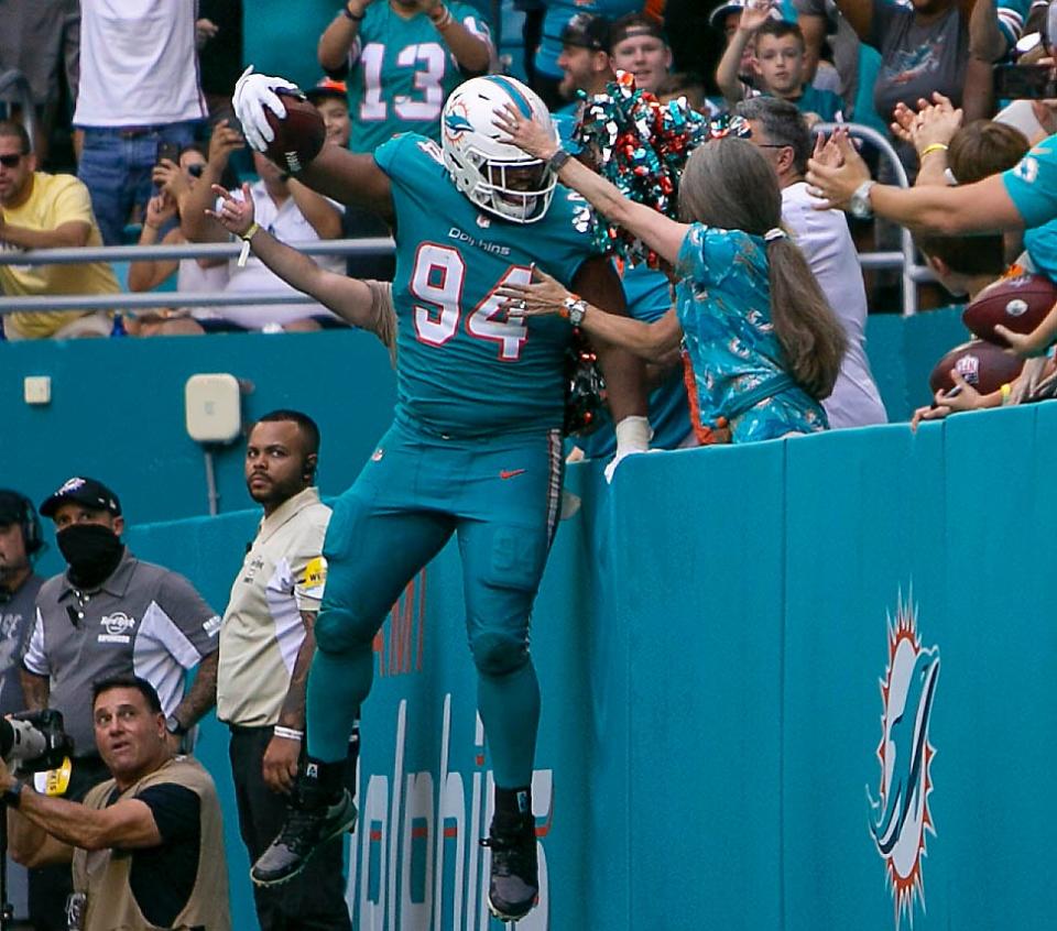 Miami Dolphins defensive end Christian Wilkins (94), jumps into the stands after scoring a touchdown during first half action agains the against the New York Jets during NFL game at Hard Rock Stadium Sunday in Miami Gardens. 