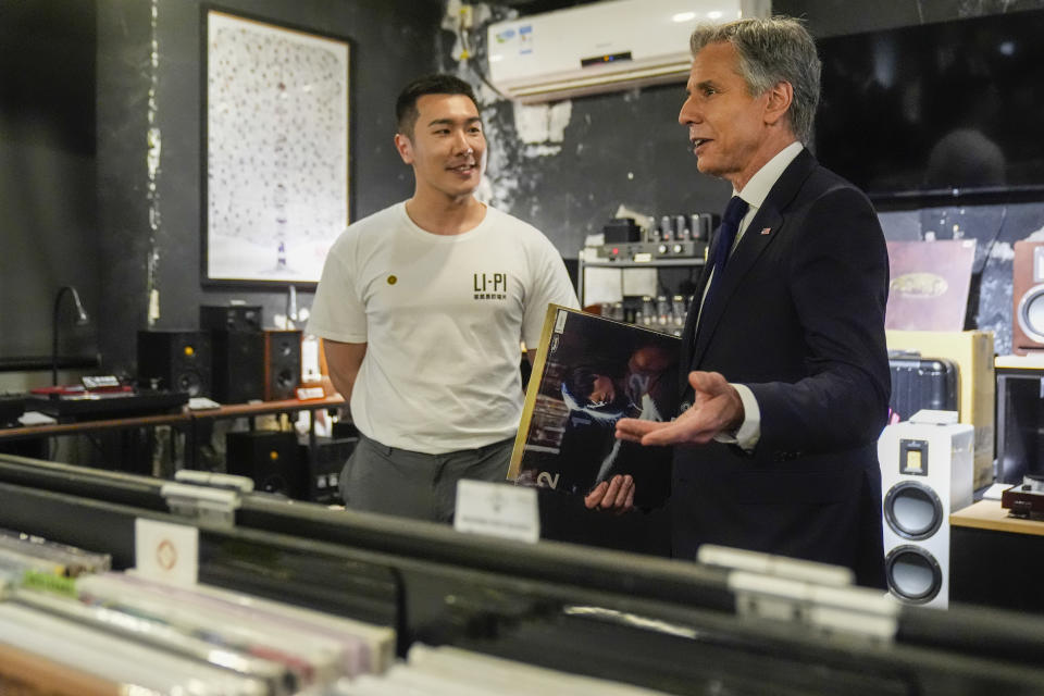 U.S. Secretary of State Antony Blinken talks with Yuxuan Zhou during a visit to Li-Pi record store in Beijing, China, Friday, April 26, 2024. (AP Photo/Mark Schiefelbein, Pool)