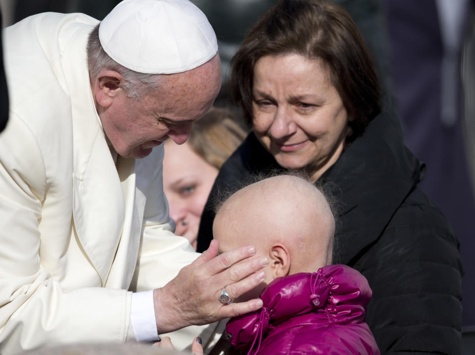 Pope Francis caresses 8-year-old Gemma at the end of his weekly general audience in St. Peter's Square at the Vatican, Wednesday, Jan. 8, 2014. (AP Photo/Alessandra Tarantino)