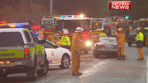 Emergency services worked to free a woman from a car wreckage after the driver of an Aston Martin fled the scene.