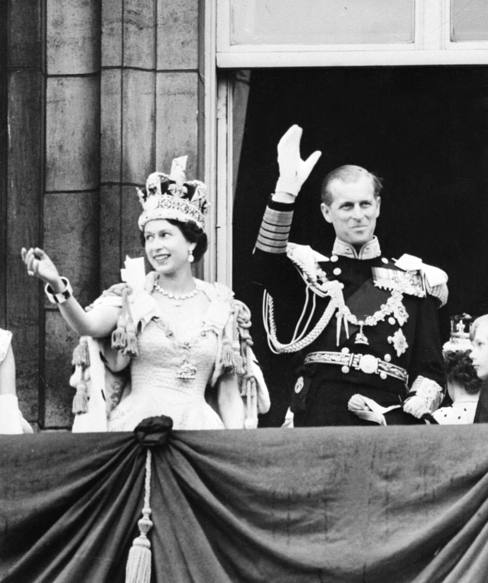 Queen Elizabeth II and Prince Philip, Duke of Edinburgh, wave to the crowd in London following her coronation on June 2, 1953.